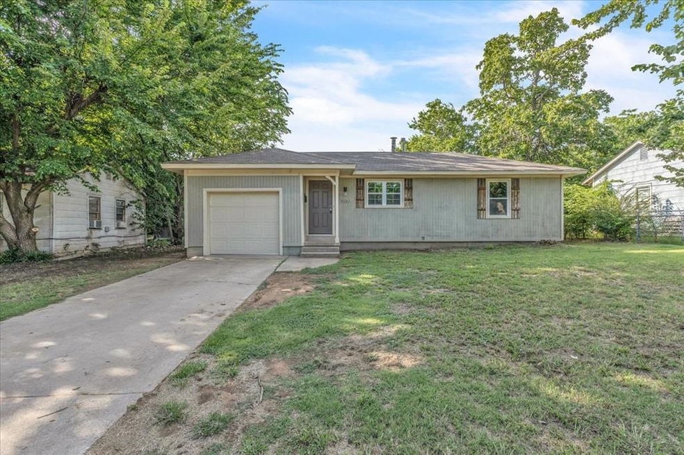 Ranch-style house with concrete driveway, a front yard, and an attached garage