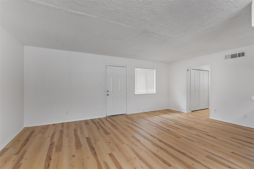 Spare room with light wood finished floors and a 