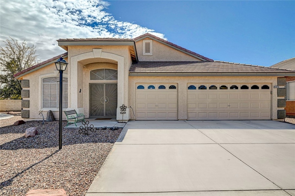 View of front of house with a tile roof, an attach