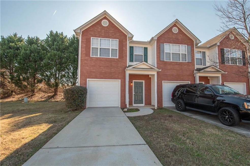 Multi unit property with a garage and a front lawn