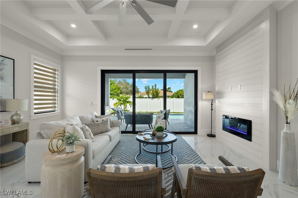 Living room with coffered ceiling, a wealth of nat