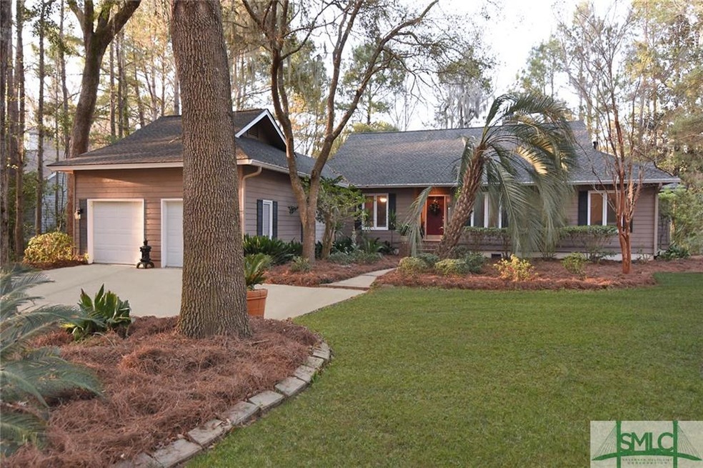 Large front yard with mature landscaping.