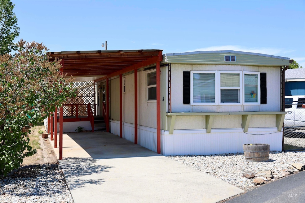 View of front of property featuring a carport and driveway