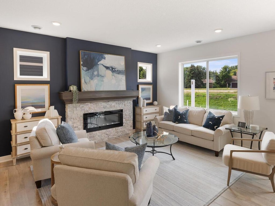 This spacious family room boasts a cozy fireplace, 9ft ceilings, and large windows that fill the space with natural light. Perfect for relaxing or entertaining, it offers both comfort and style. *selections may vary from images