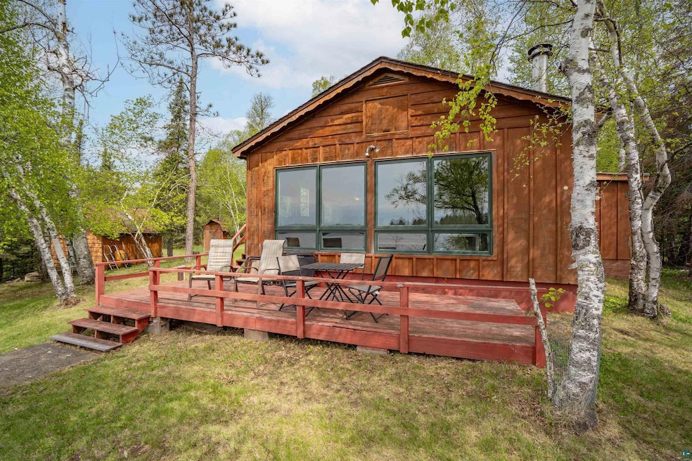 Rear view of house featuring a yard and a deck