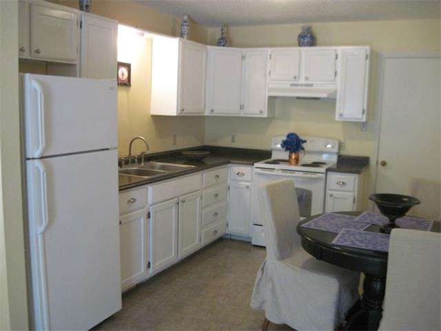 Unit B: Kitchen, laundry, and bath tile floor repl