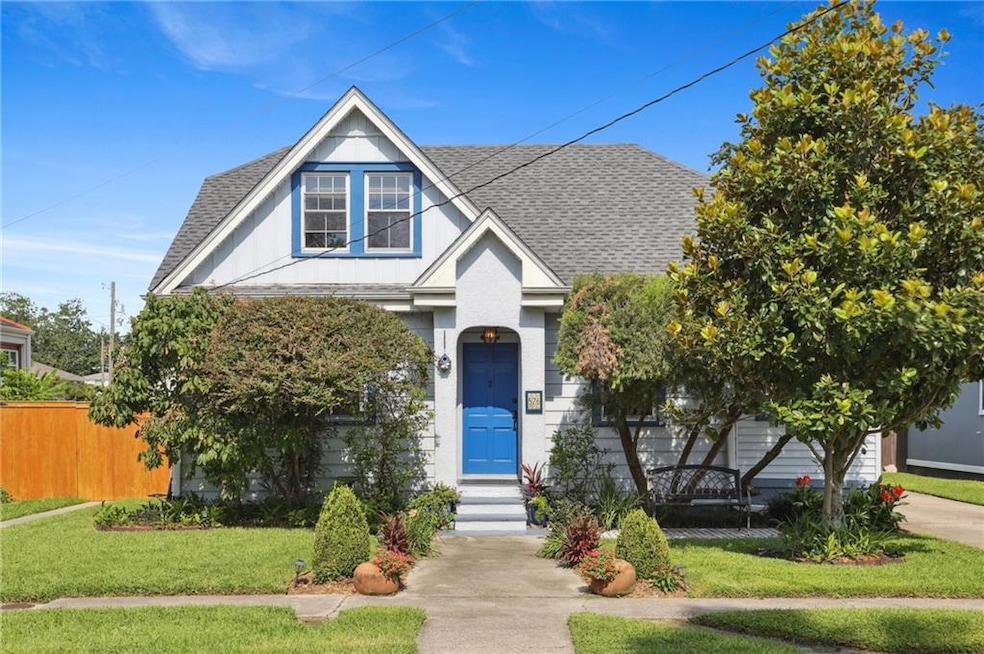 Charming cottage with great curb appeal and vibrant blue front door.