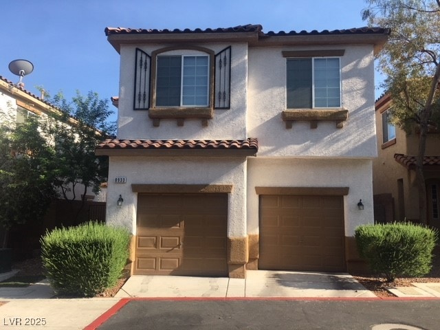 Mediterranean / spanish-style house with an attach