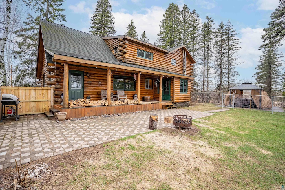 Rear view of house with a yard and a patio area