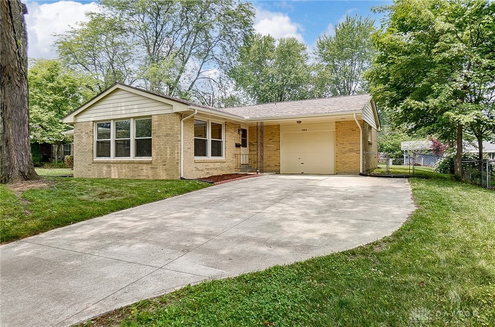 Newer cement driveway with extended area for more parking.