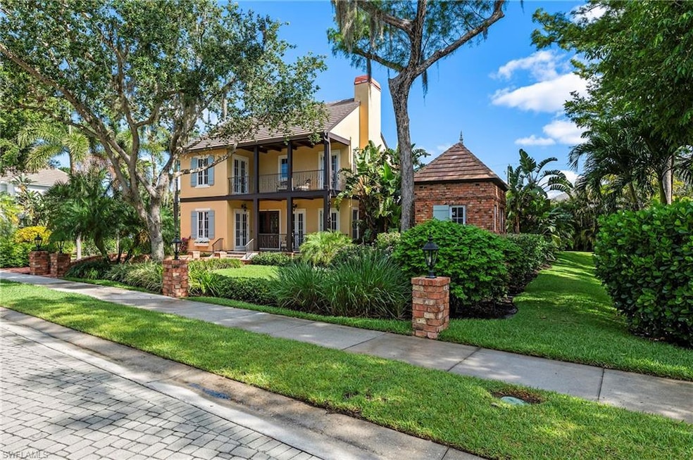 View of front of home featuring two porches, main house, pool house