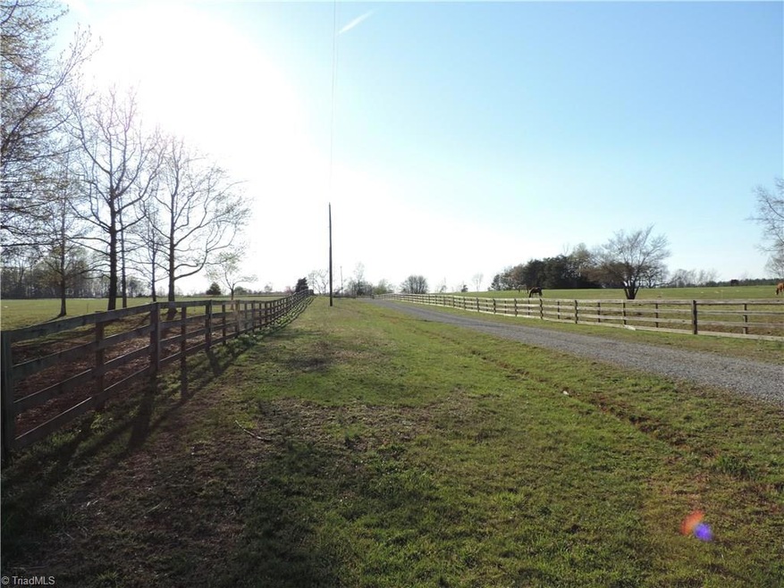 The house and barn are situated way back from the road.  Fenced pastures border the drive on each side.