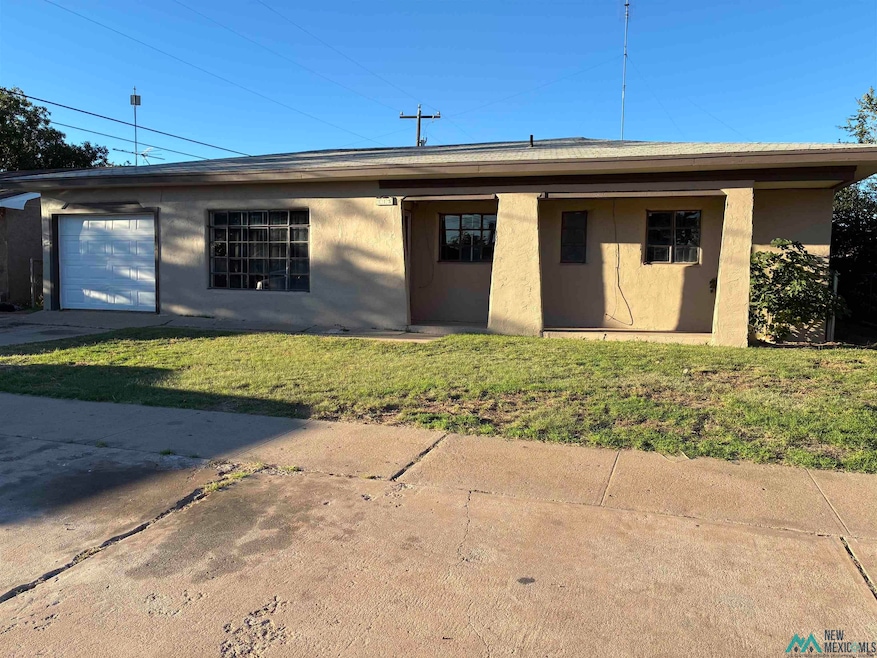 Single story home with stucco siding and a front lawn