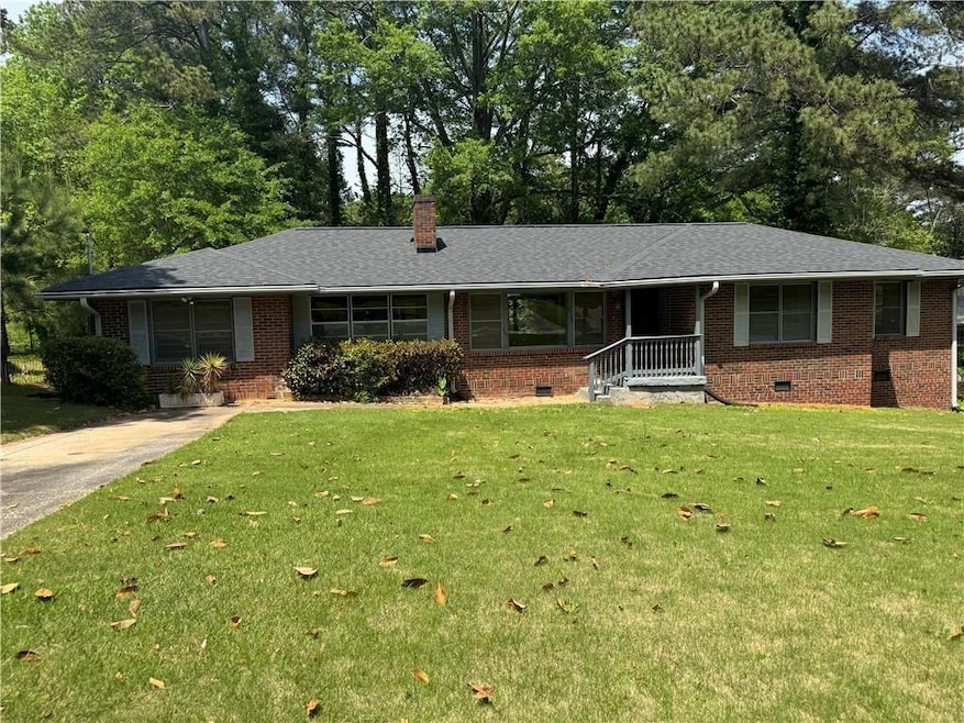 Ranch-style house with a chimney, a shingled roof,