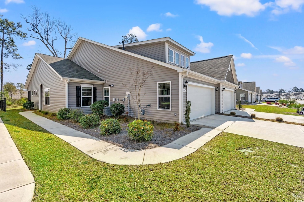 View of home's exterior featuring concrete drivewa
