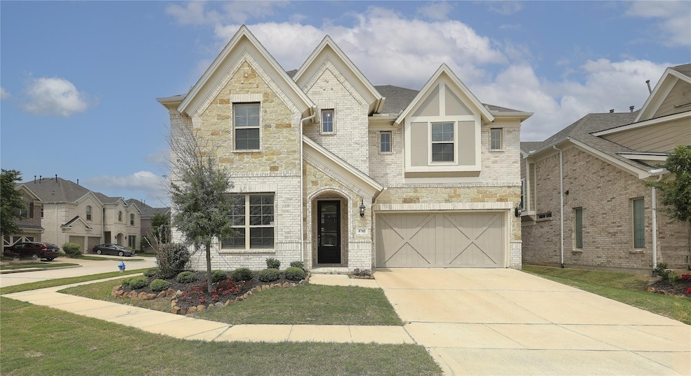 View of front of home with a front lawn and a garage
