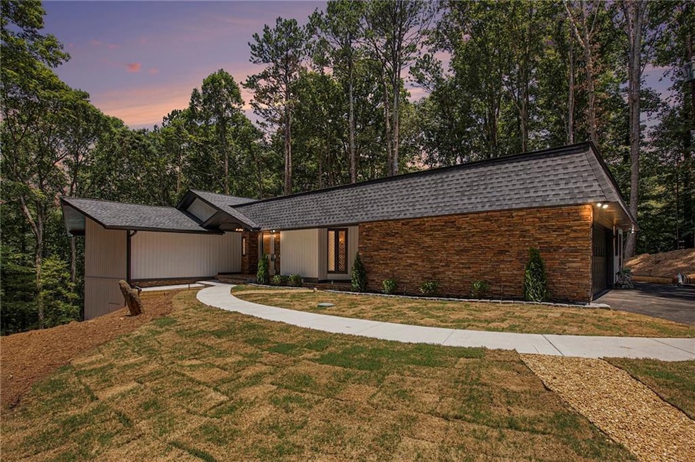 View of front of property with roof with shingles and a yard