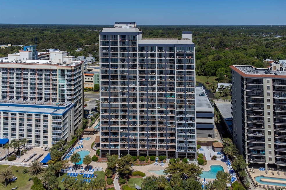 Drone / aerial view featuring a wooded view