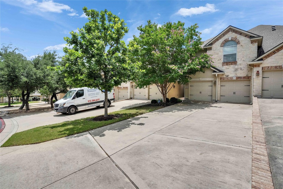 View of front facade with concrete driveway, ston
