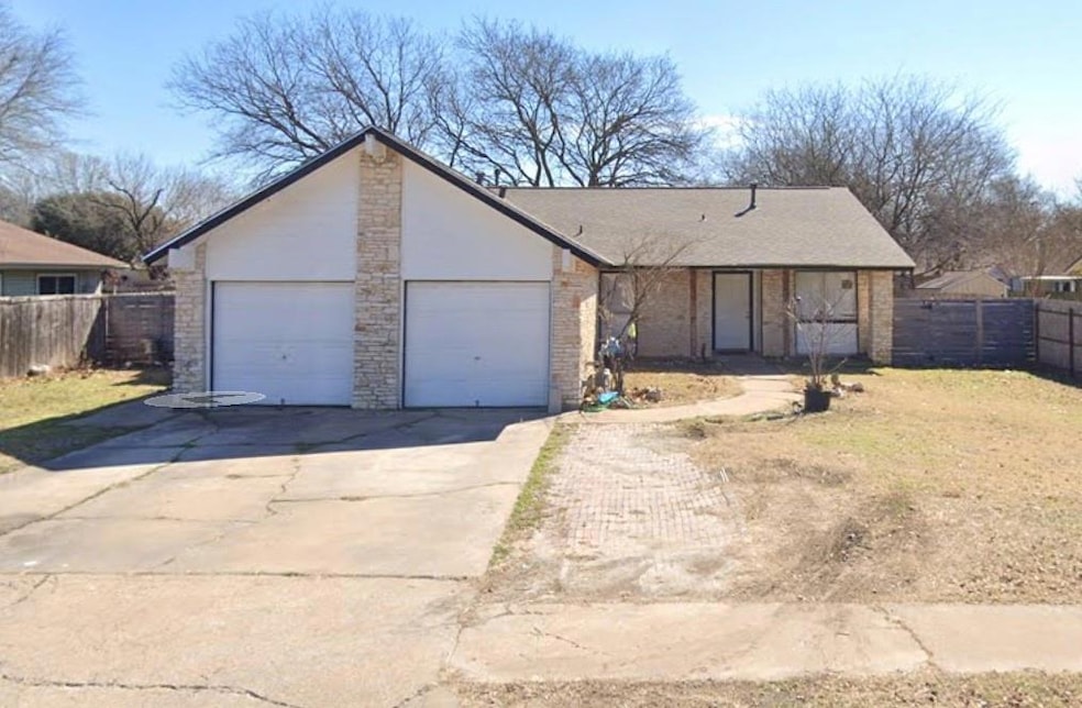 Ranch-style home with driveway, an attached garag