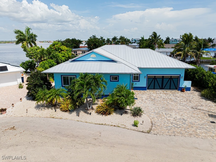 View of front of property with metal roof, a garag