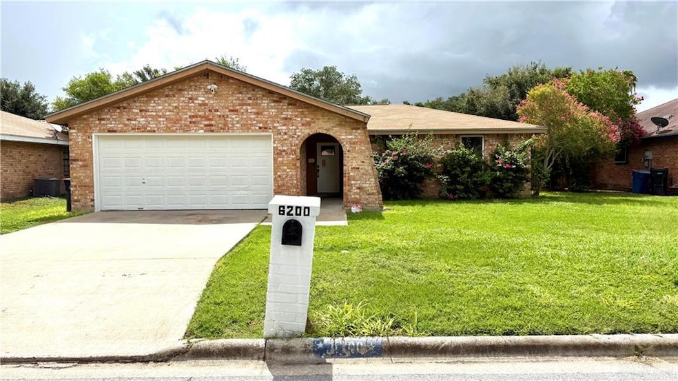 Single story home with brick siding, a front yard, concrete driveway, and a garage