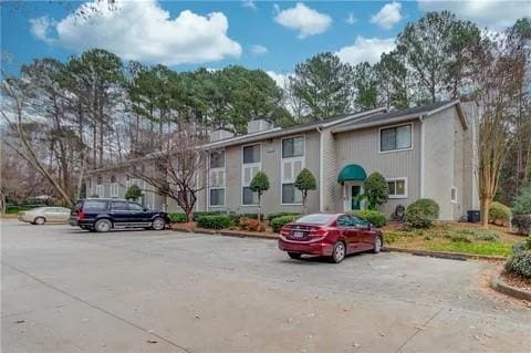 View of front of house with uncovered parking and 