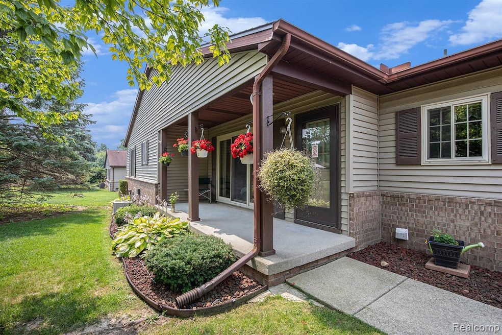 Property entrance featuring covered porch, a yard, brick siding, and crawl space