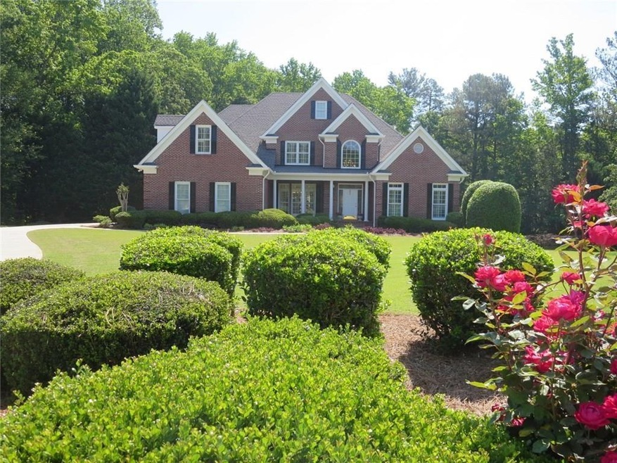 This gorgeous 4-sided brick home is set on a huge 