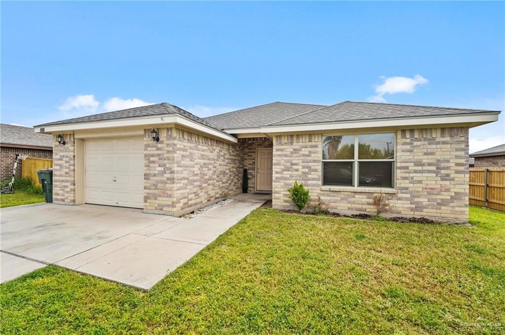 View of front of home featuring a garage and a front yard