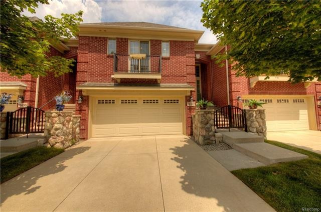 Front of home with balcony, private entry and 2 ca