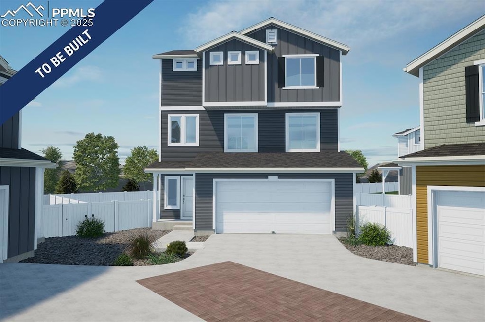 View of front facade with a garage, decorative dri