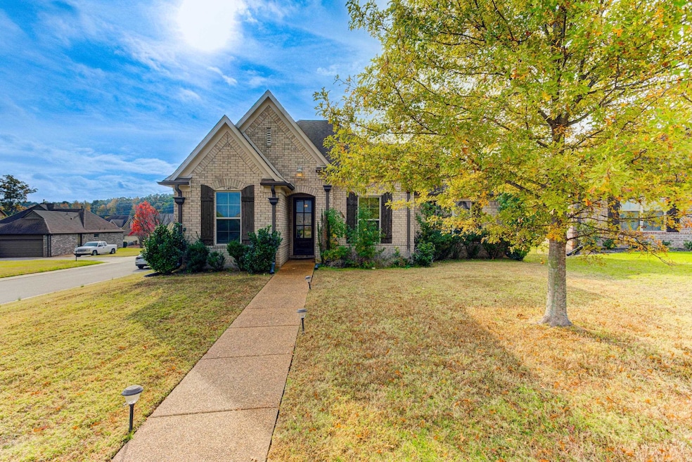View of front of property featuring a front lawn and brick siding