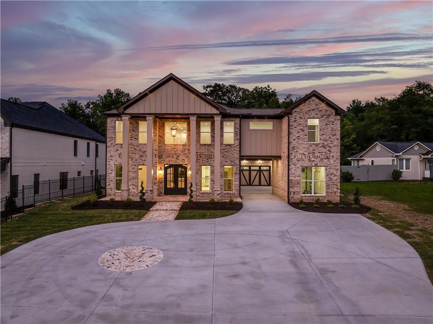 View of front of home with french doors, board and batten siding, and brick siding