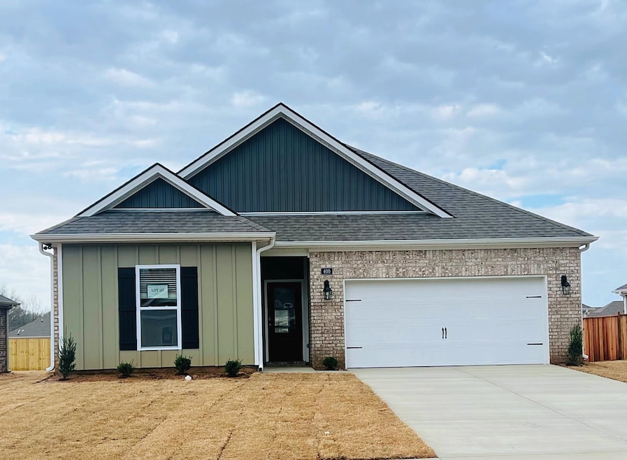 Ranch-style home with fence, driveway, an attached
