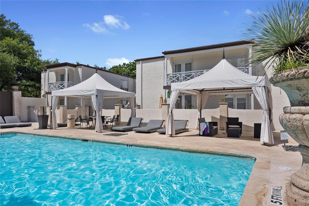 Pool with a patio area and fence