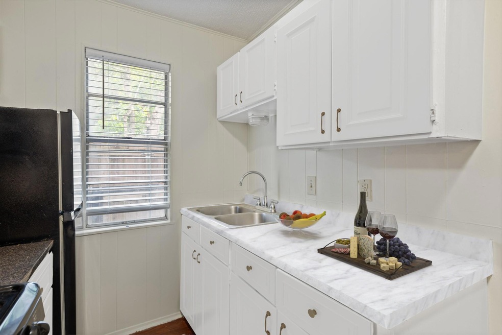Kitchen with a decorative wall, healthy amount of