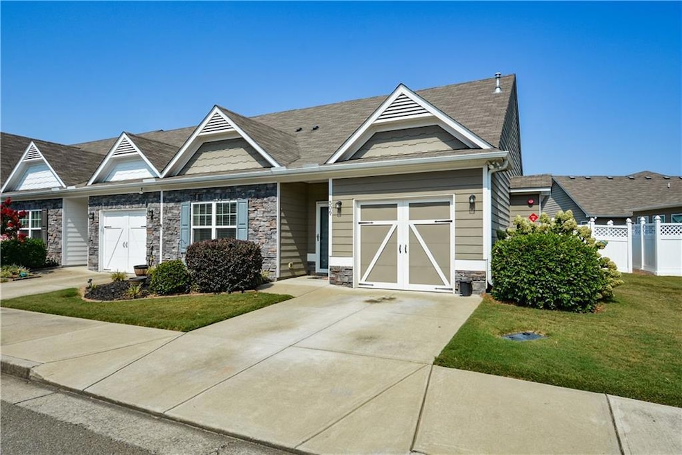 View of front of home with a front lawn and a gara