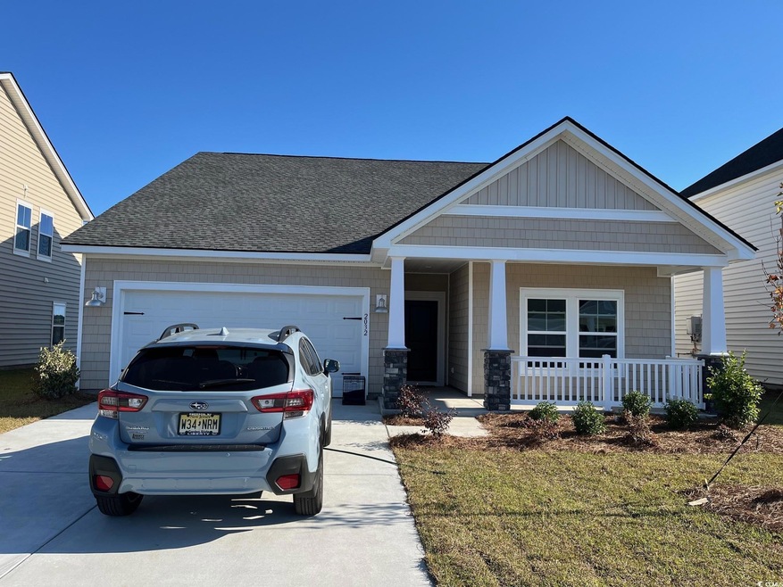 Craftsman-style home featuring covered porch and a