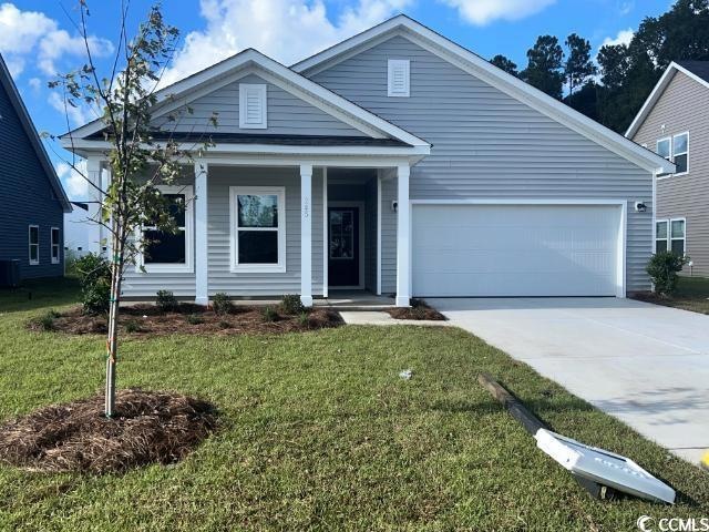 View of front of home with cooling unit, a porch, 