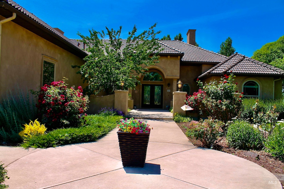 Entrance to property with french doors, a chimney, stucco siding, and a tile roof