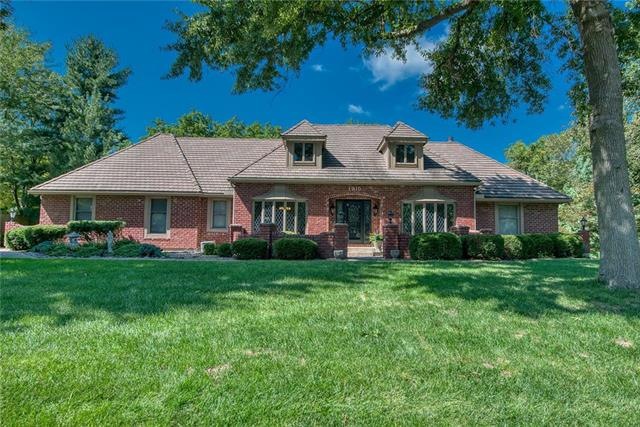Stately front entrance with formal brick courtyard