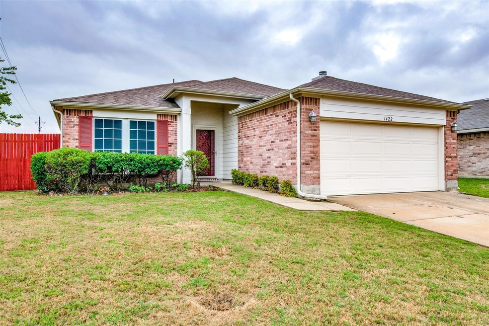Ranch-style home featuring a garage and a front yard