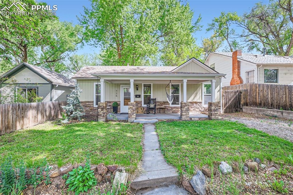View of front of property with stone siding and covered porch