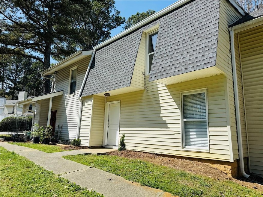 View of front of property featuring mansard roof a