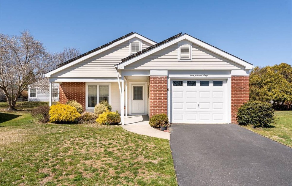 Ranch-style house featuring aphalt driveway, brick