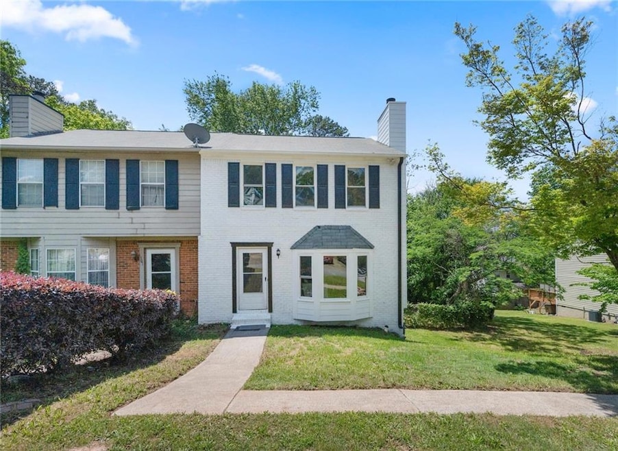 Townhome / multi-family property with a chimney, b