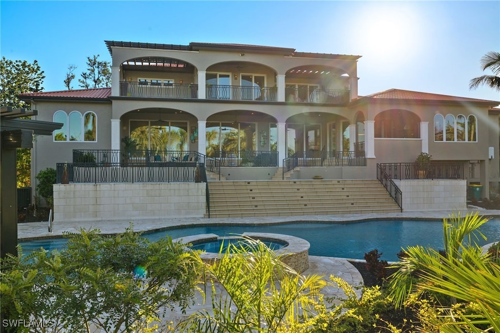 Back of house featuring a balcony and a pool with