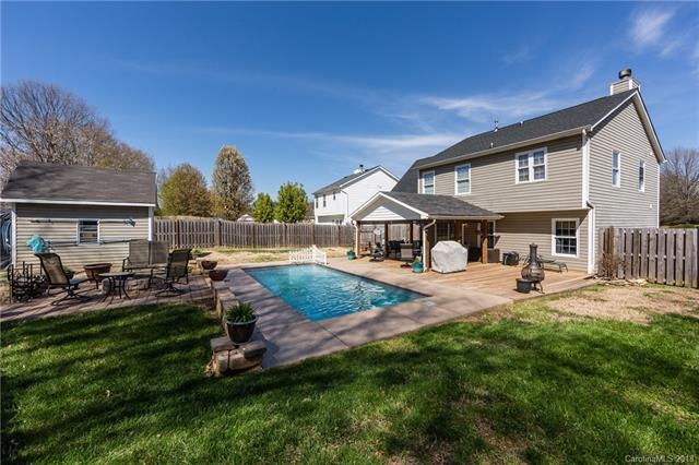 Fenced in yard, salt-water pool, fire-pit. This is the perfect yard for nearly year-round outdoor living!