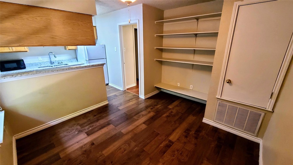 Kitchen featuring freestanding refrigerator, blac